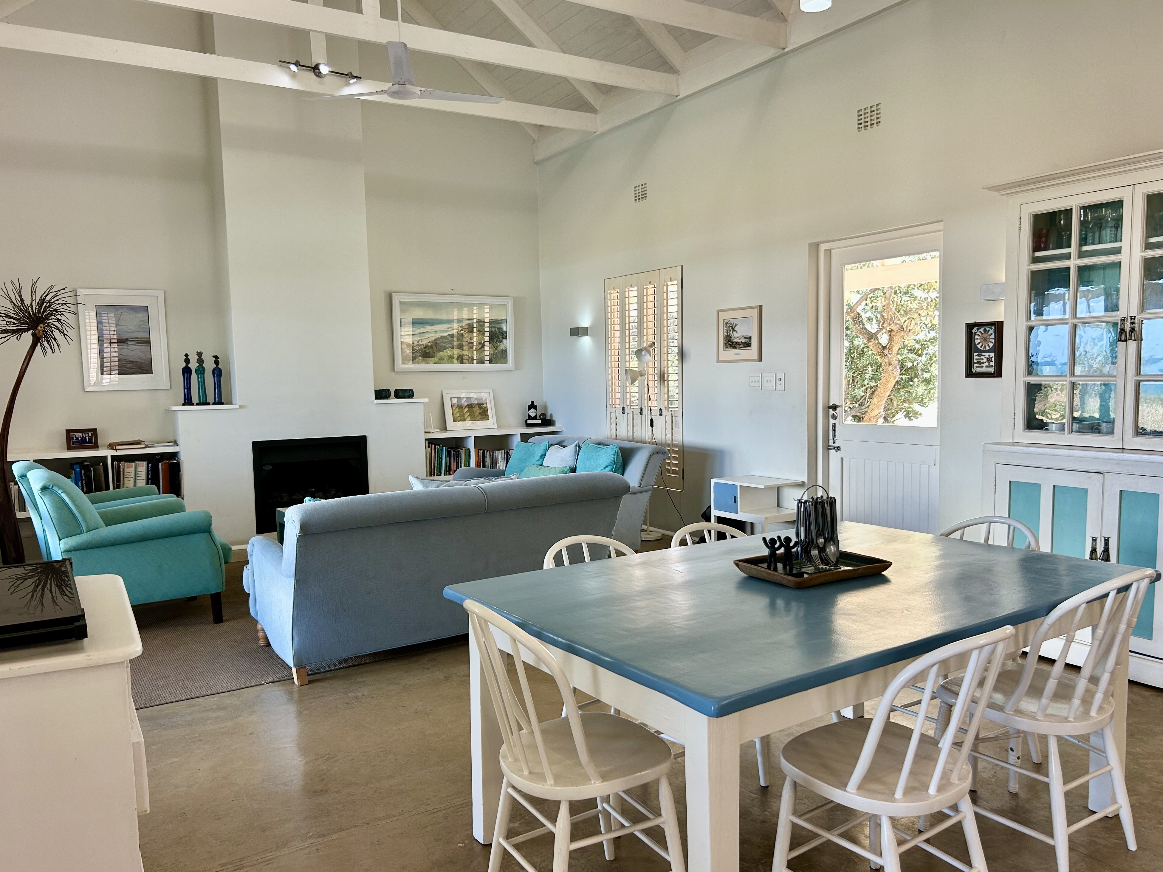 Warm family dining area with ocean views through open windows